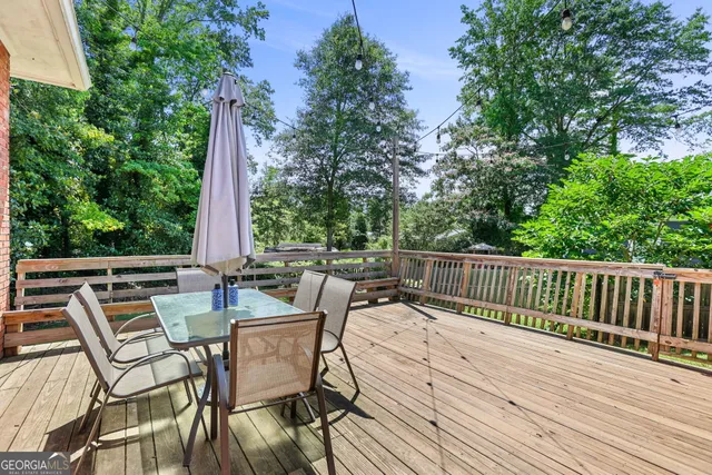 a view of a patio with table and chairs