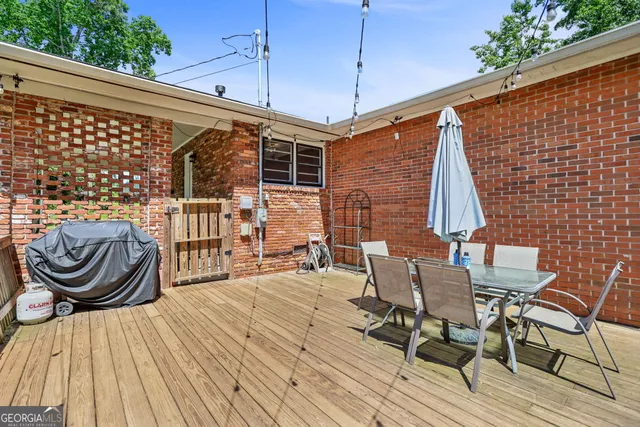 a backyard of a house with plants and large trees