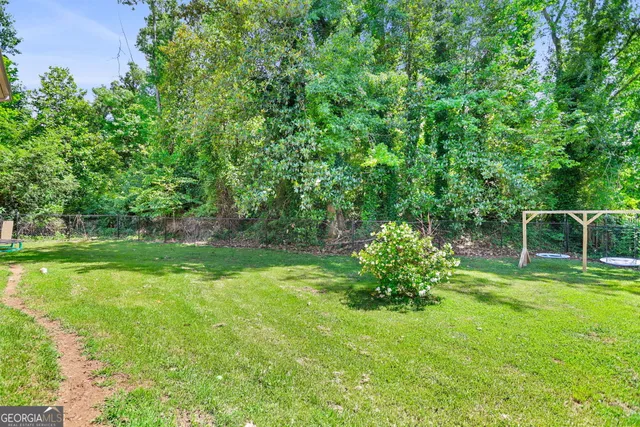 a garden with trees in the background