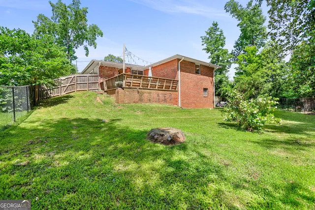 a view of a backyard with a small deck