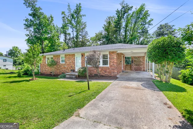a front view of house with yard and green space