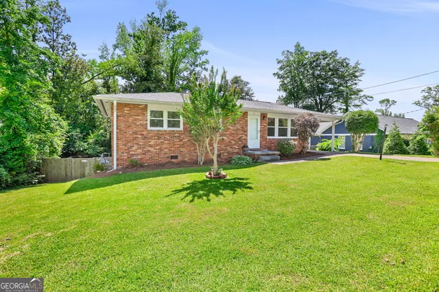 a front view of house with yard and green space