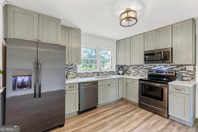 a view of a livingroom with wooden floor and furniture