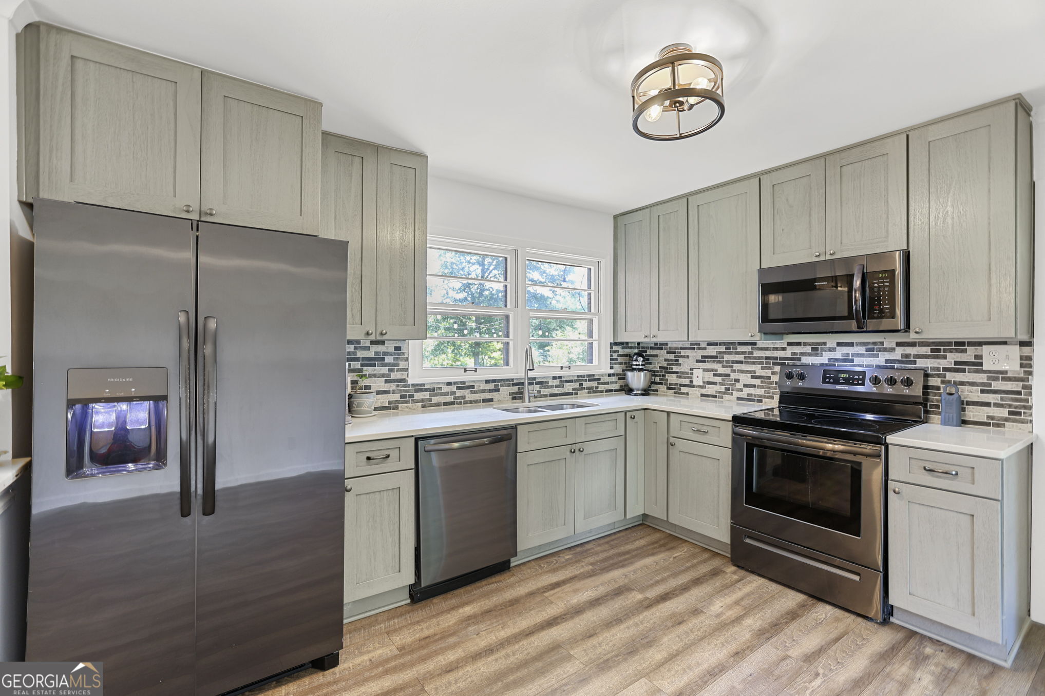 12 Conner Drive Newnan, GA 30263 - Photo 9 of 28 a kitchen with stainless steel appliances granite countertop a stove a sink and a refrigerator