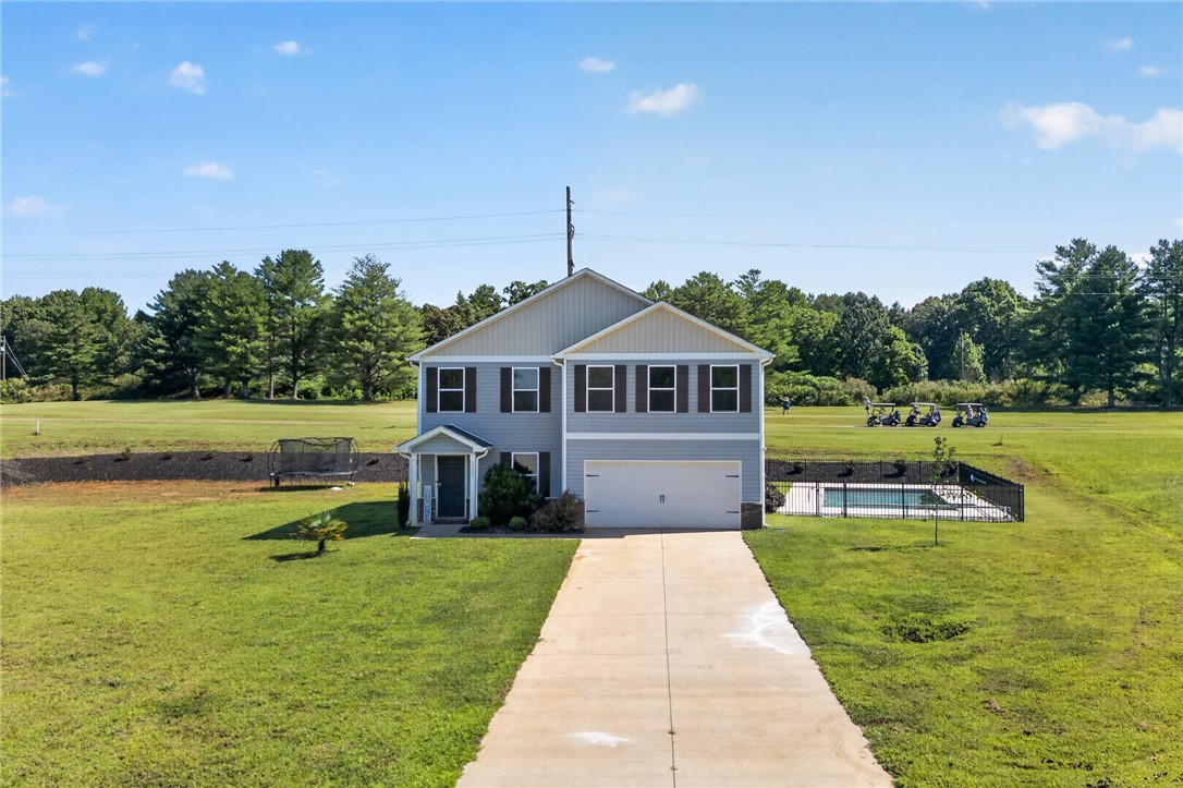 2007 Aberdeen Lane Walhalla, SC 29691 - Photo 39 of 41 A classic two-story residence with a private pool and integrated garage, set against a verdant landscape.