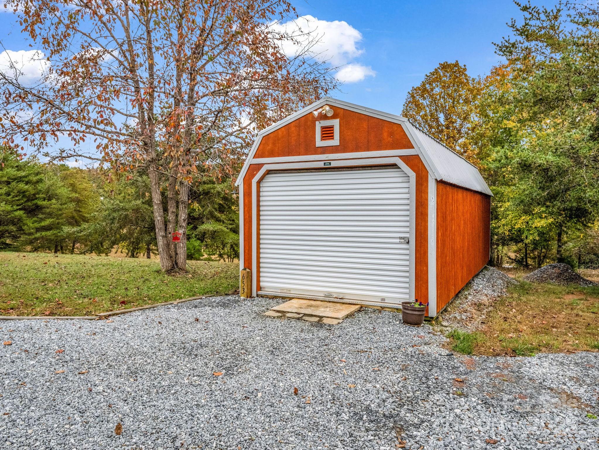 653 Moonlight Pass Union Mills, NC 28167 - Photo 36 of 44 a front view of a house with a yard and garage