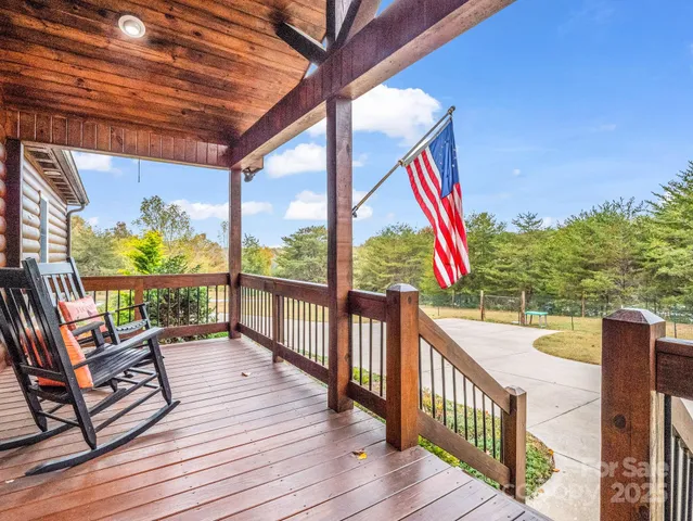 a view of a balcony with couch and wooden floor