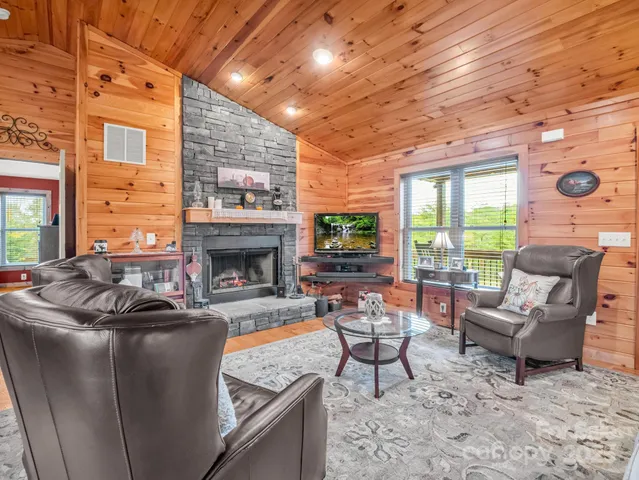 a living room with furniture a fireplace and a table