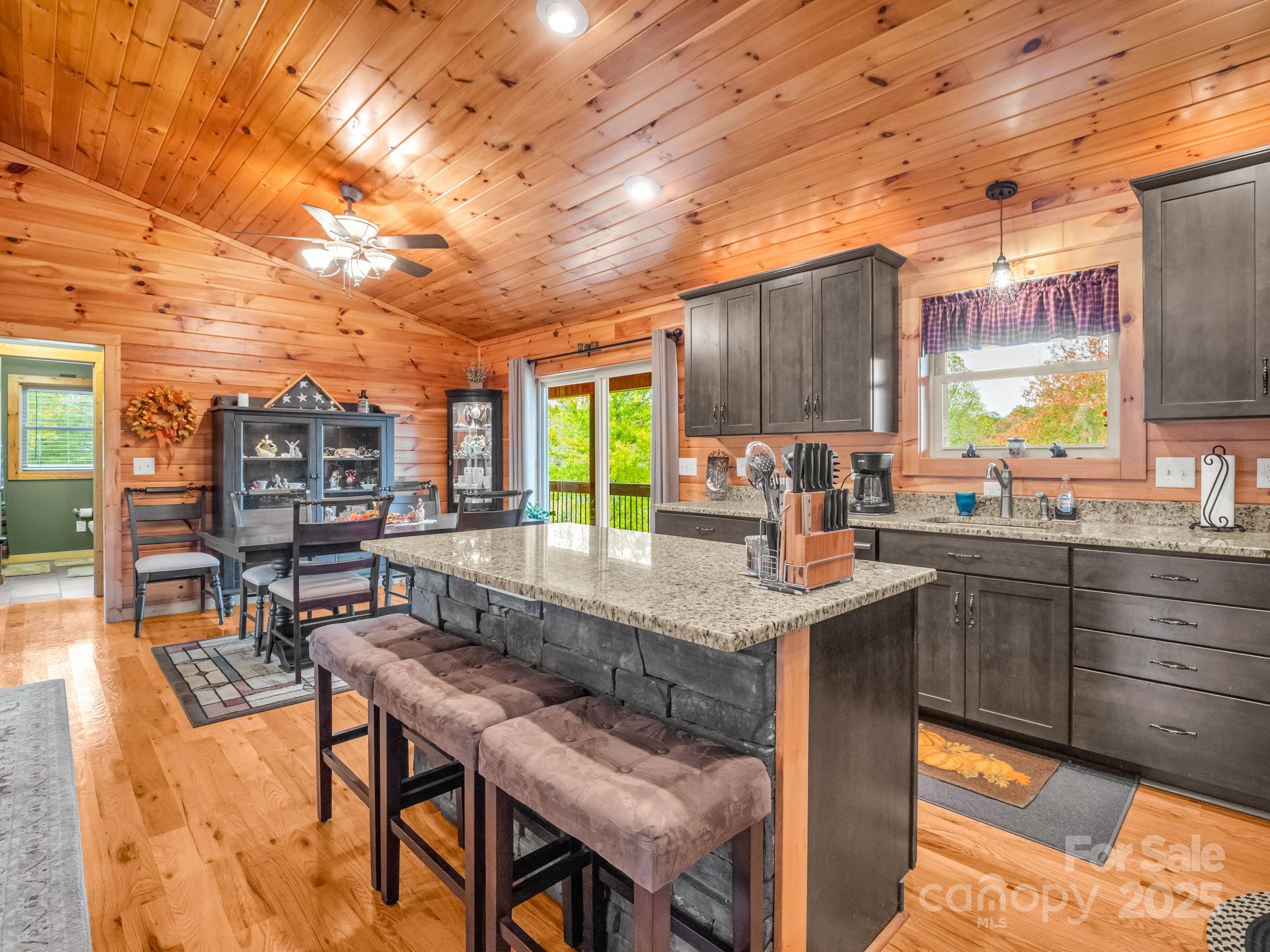 653 Moonlight Pass Union Mills, NC 28167 - Photo 9 of 44 a kitchen with stainless steel appliances granite countertop table chairs sink and cabinets
