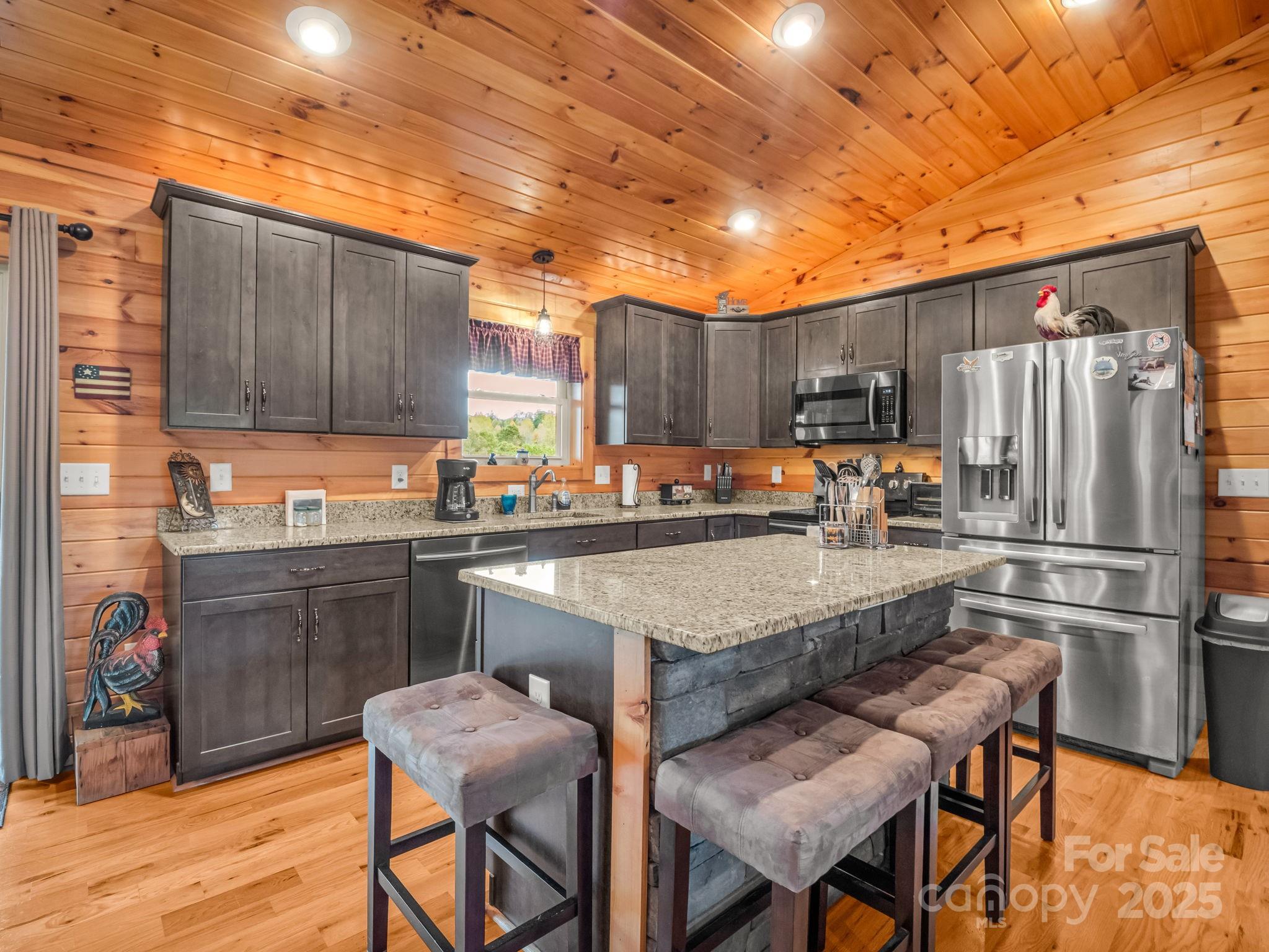653 Moonlight Pass Union Mills, NC 28167 - Photo 10 of 44 a kitchen with granite countertop a refrigerator stove top oven and sink