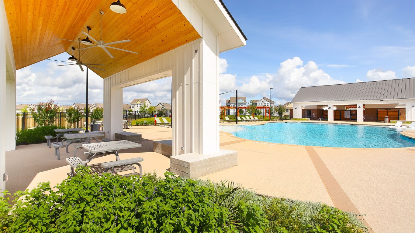 3085 Winding Creek Road Kyle, TX 78640 - Photo 6 of 17 Community pool with a patio area and ceiling fan