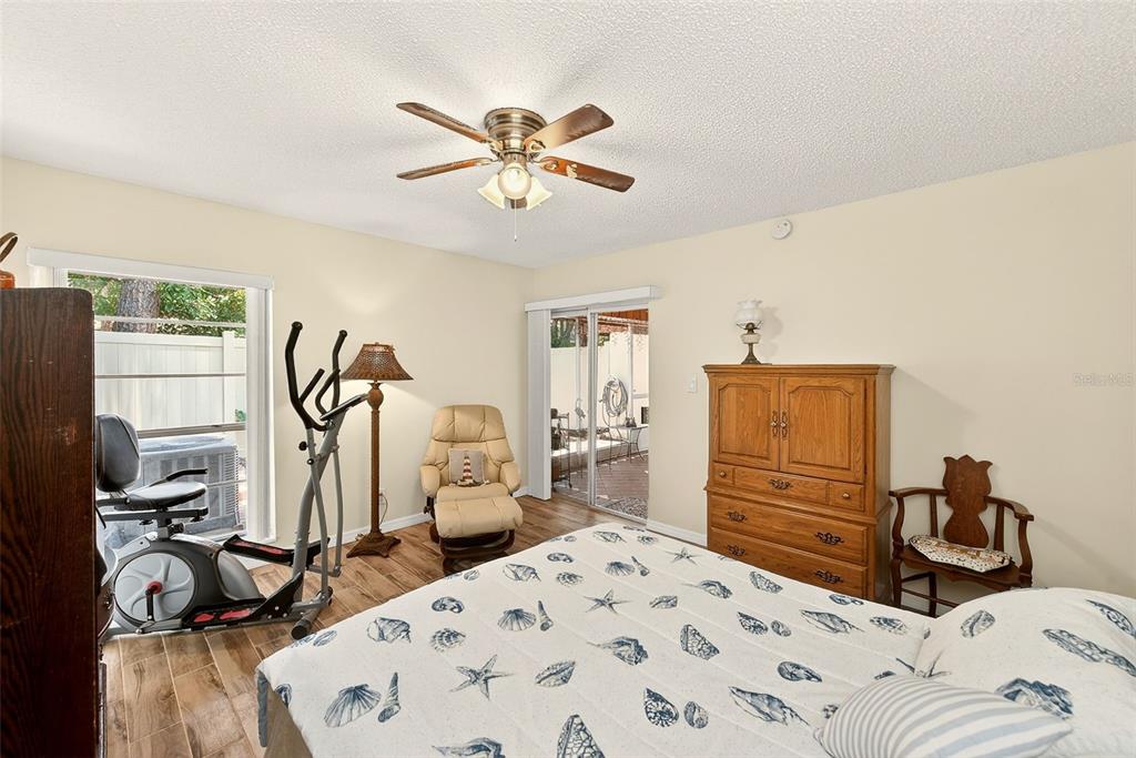 2064 Sunset Point Road, Unit 73 Clearwater, FL 33765 - Photo 26 of 58 a bedroom with a bed and a flat tv screen on the dresser