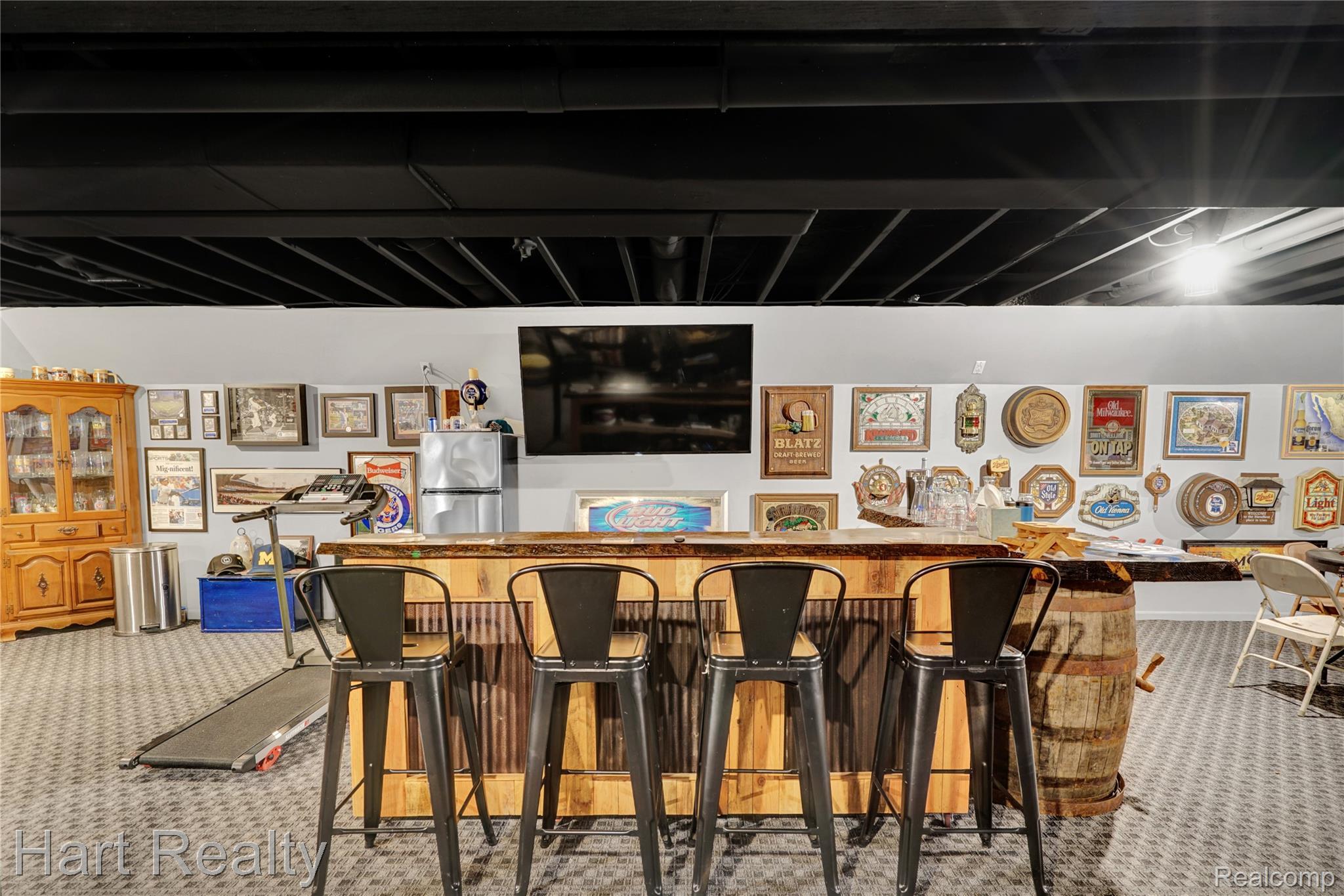 7167 Brown School Road North Branch, MI 48461 - Photo 36 of 51 Finished basement featuring a custom bar with a natural wood countertop and corrugated metal accents, recessed lighting, and a dark painted exposed ceiling