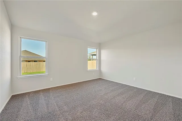 a view of kitchen with sink and refrigerator