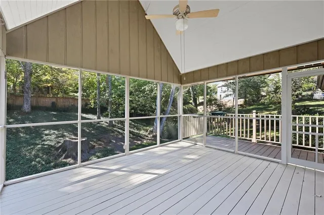 a view of a deck with wooden floor and fence