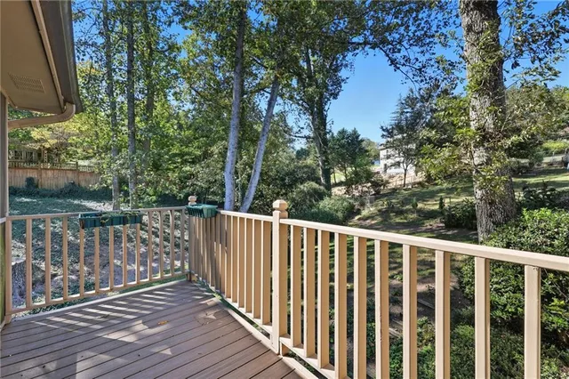 a balcony with wooden floor and fence