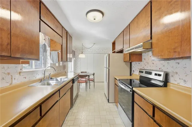 a kitchen with cabinets and chairs