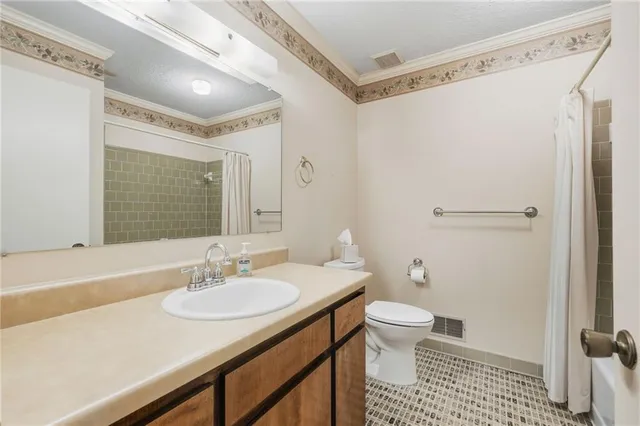 a bathroom with a sink toilet double vanity and shower