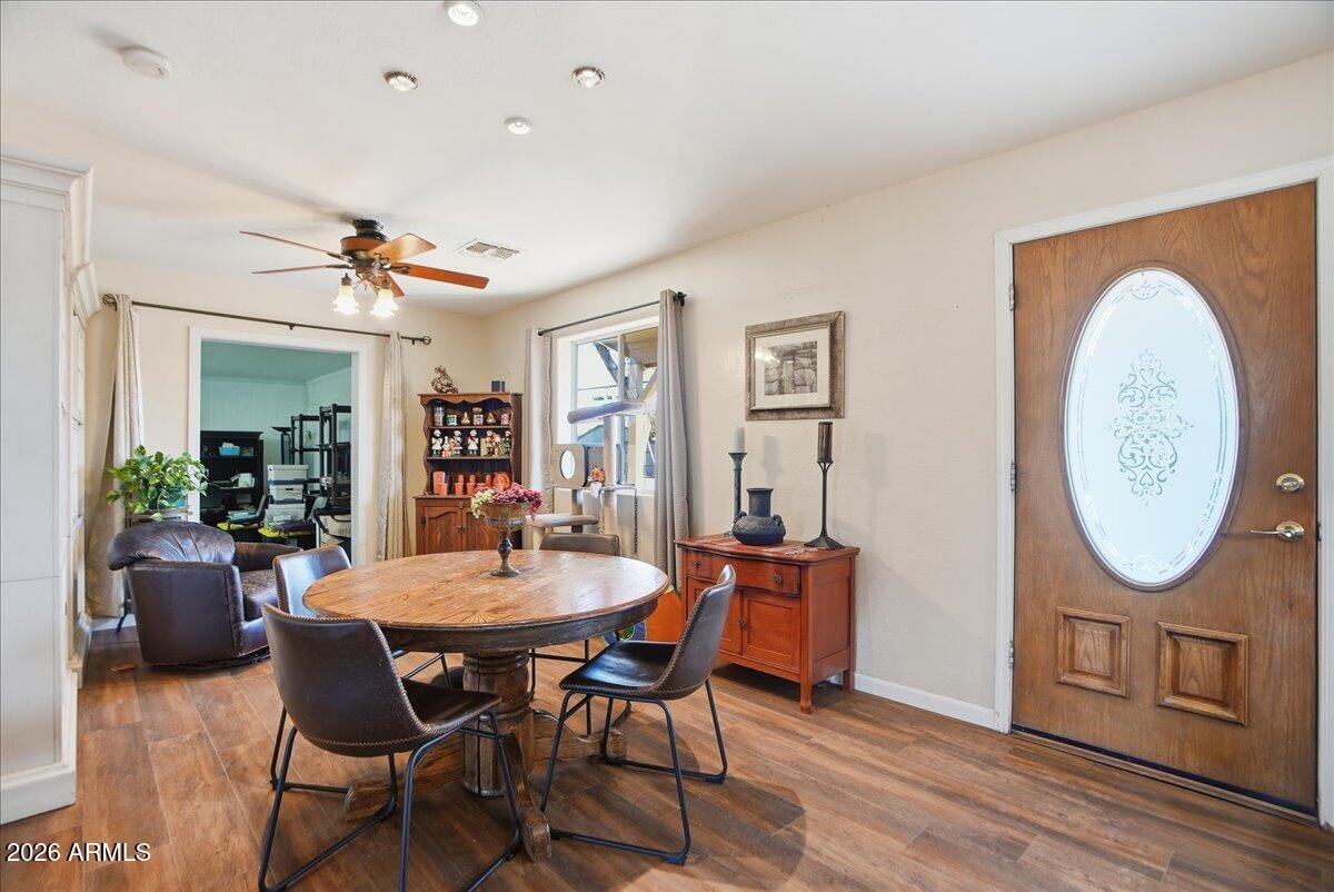 1414 West Ocotillo Road San Tan Valley, AZ 85140 - Photo 10 of 62 a dining room with furniture a rug and a mirror