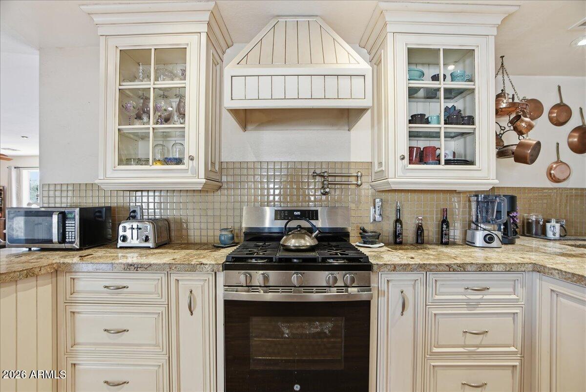 1414 West Ocotillo Road San Tan Valley, AZ 85140 - Photo 15 of 62 a kitchen with granite countertop a sink stove and cabinets