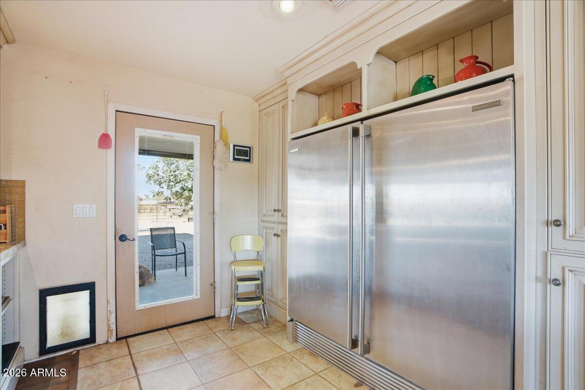 1414 West Ocotillo Road San Tan Valley, AZ 85140 - Photo 17 of 62 a view of a refrigerator in kitchen and an empty room