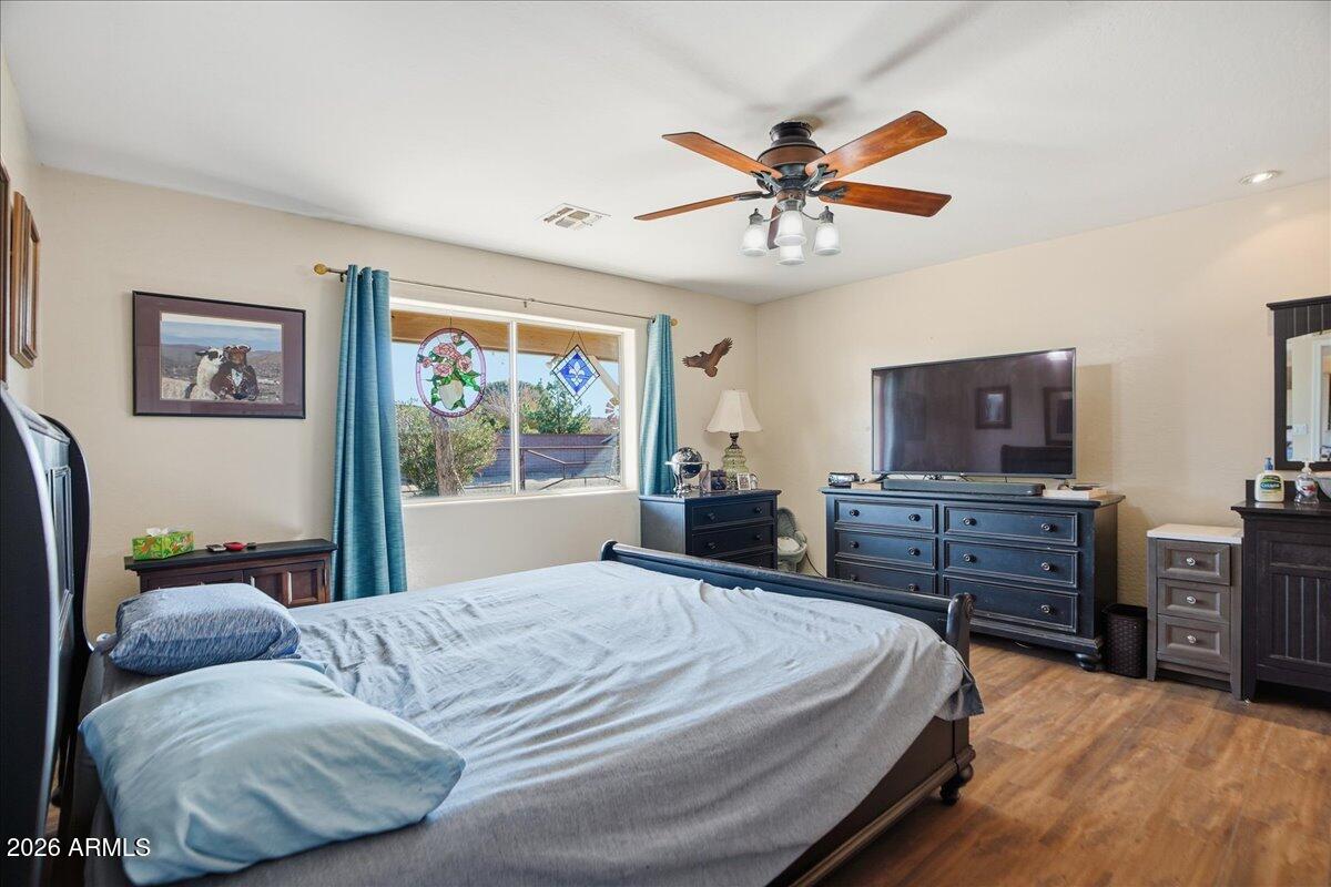 1414 West Ocotillo Road San Tan Valley, AZ 85140 - Photo 18 of 62 a bedroom with a bed and wooden floor