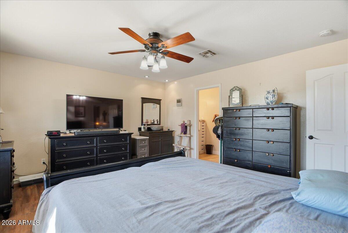 1414 West Ocotillo Road San Tan Valley, AZ 85140 - Photo 19 of 62 a bedroom with a bed and a flat screen tv