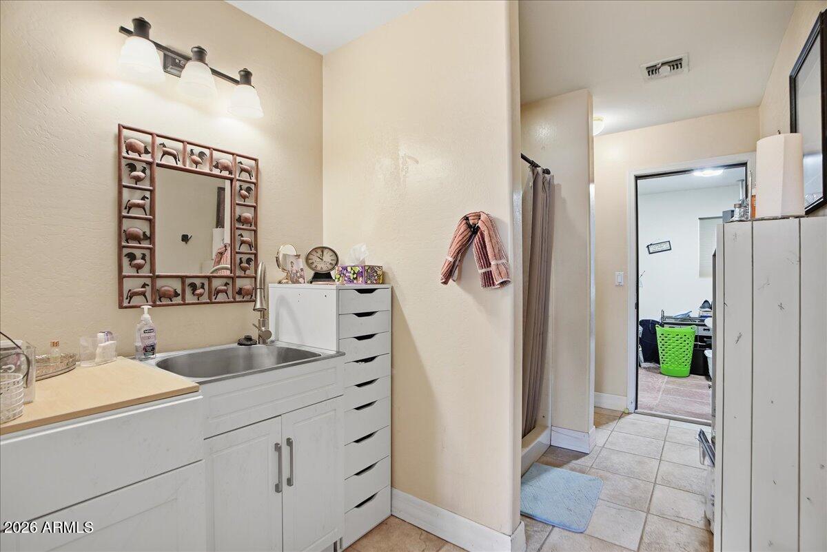 1414 West Ocotillo Road San Tan Valley, AZ 85140 - Photo 21 of 62 a bathroom with a sink and a mirror