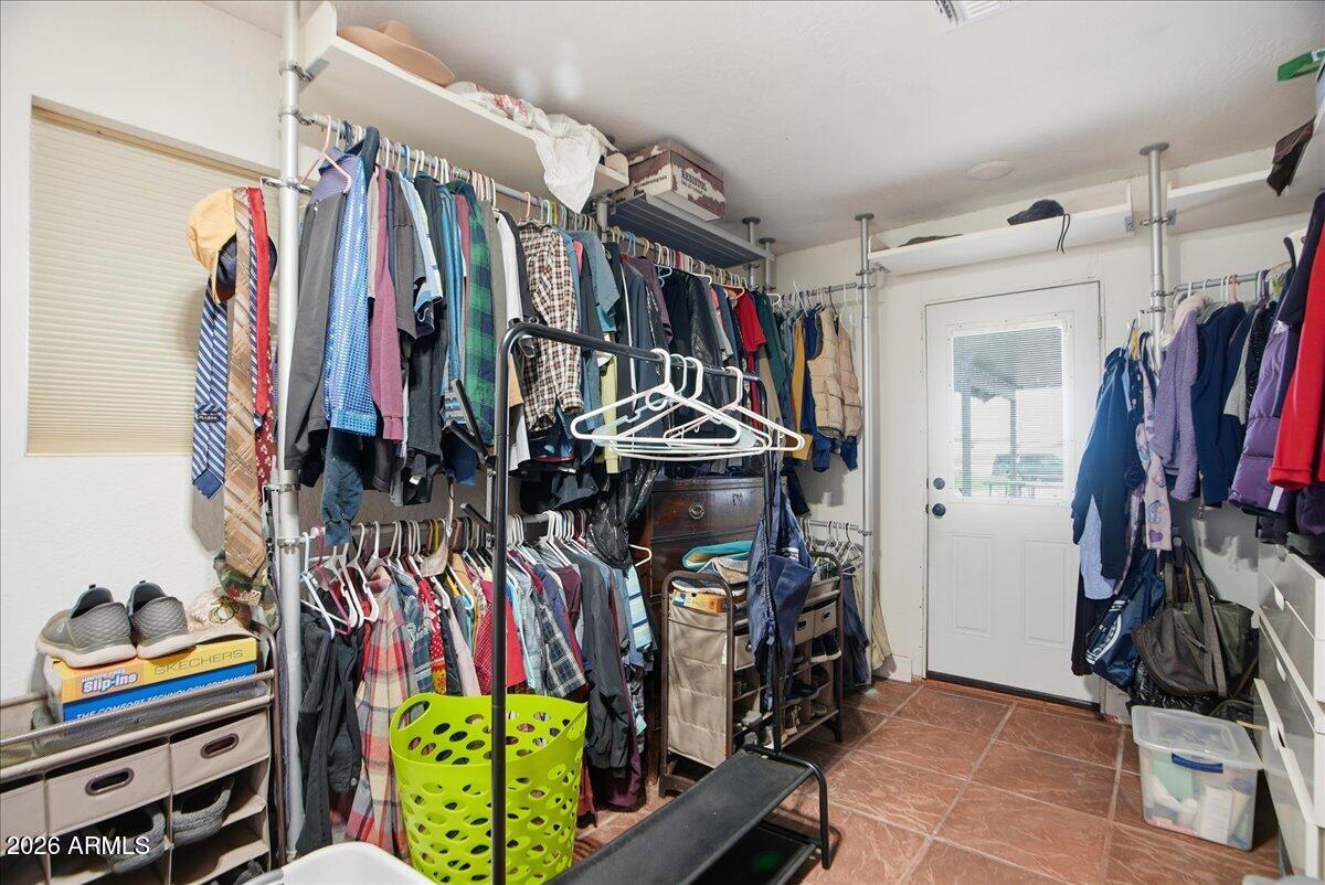 1414 West Ocotillo Road San Tan Valley, AZ 85140 - Photo 23 of 62 a view of walk in closet with clothes and shoes