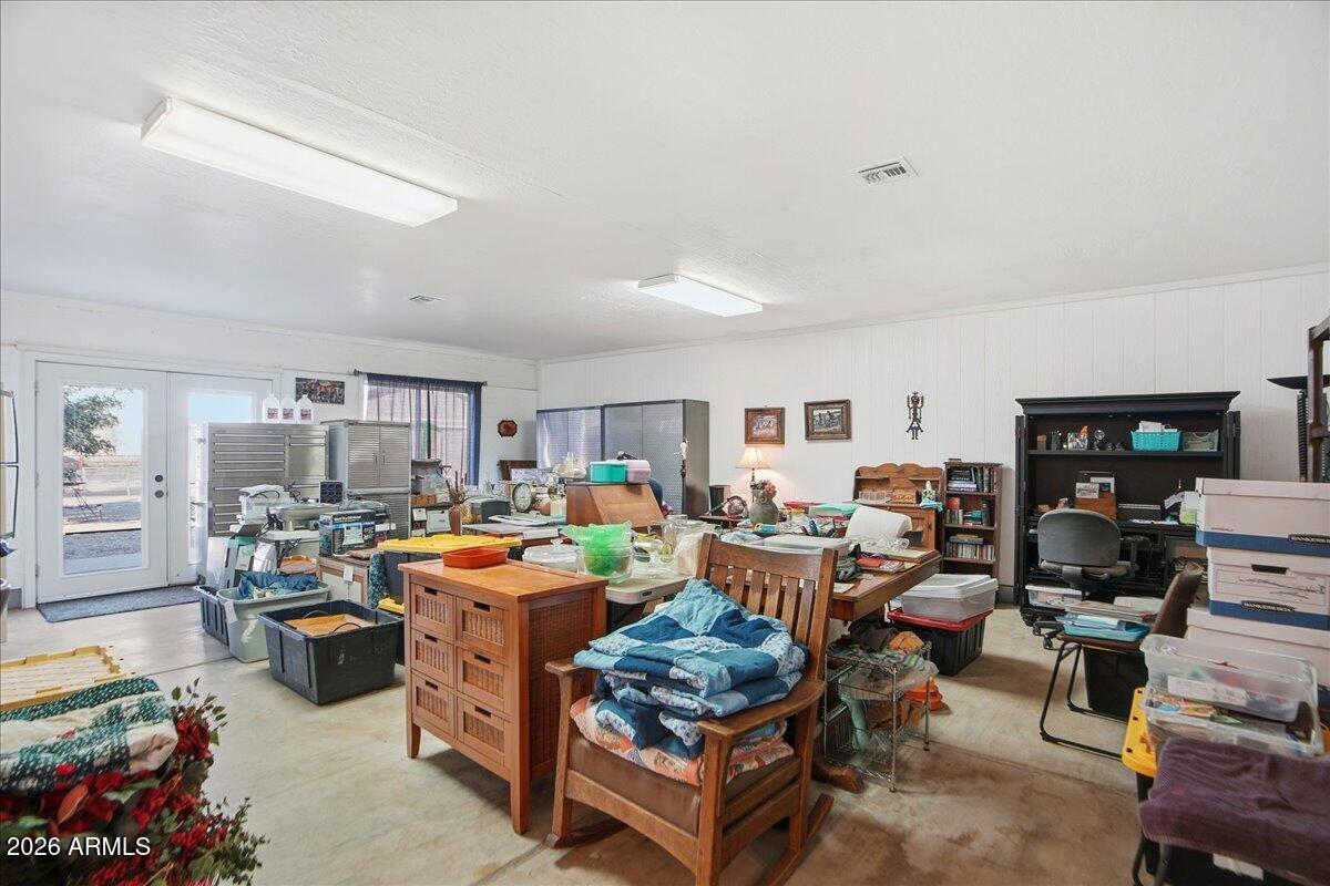 1414 West Ocotillo Road San Tan Valley, AZ 85140 - Photo 24 of 62 a living room with lots of furniture and clutter