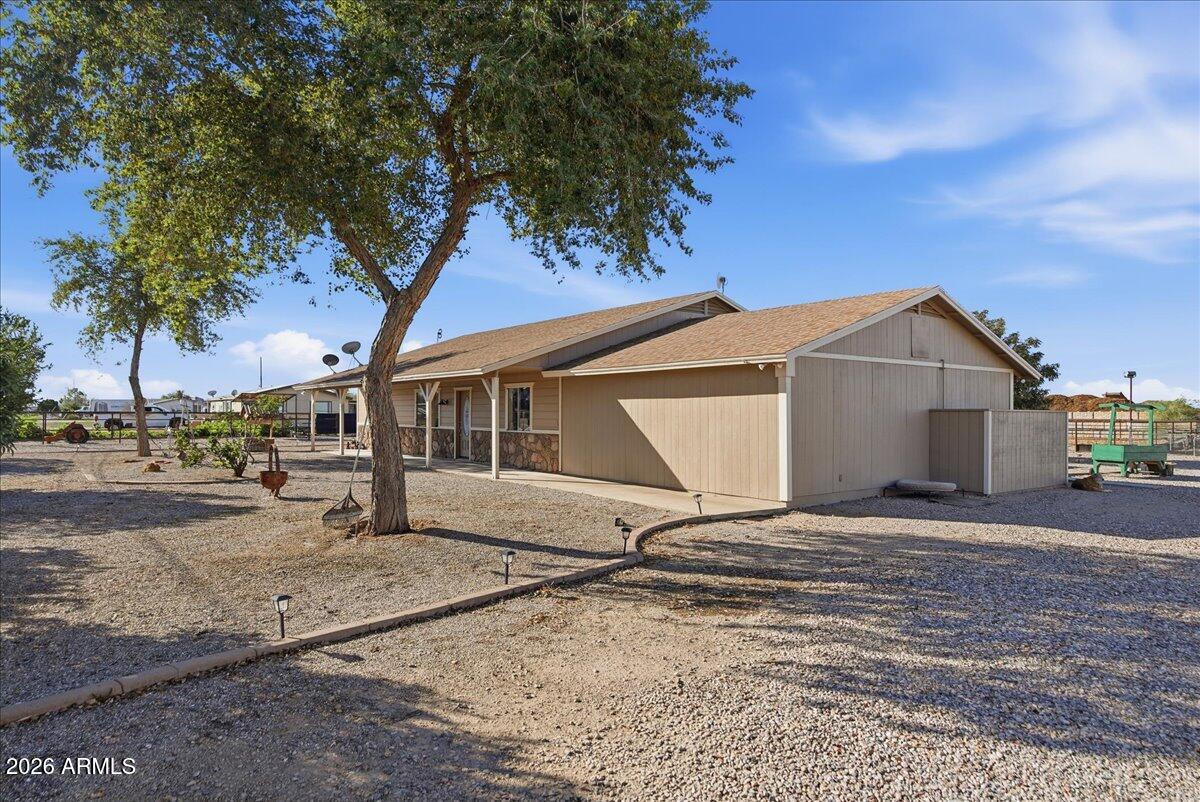 1414 West Ocotillo Road San Tan Valley, AZ 85140 - Photo 2 of 62 a house with trees in the background