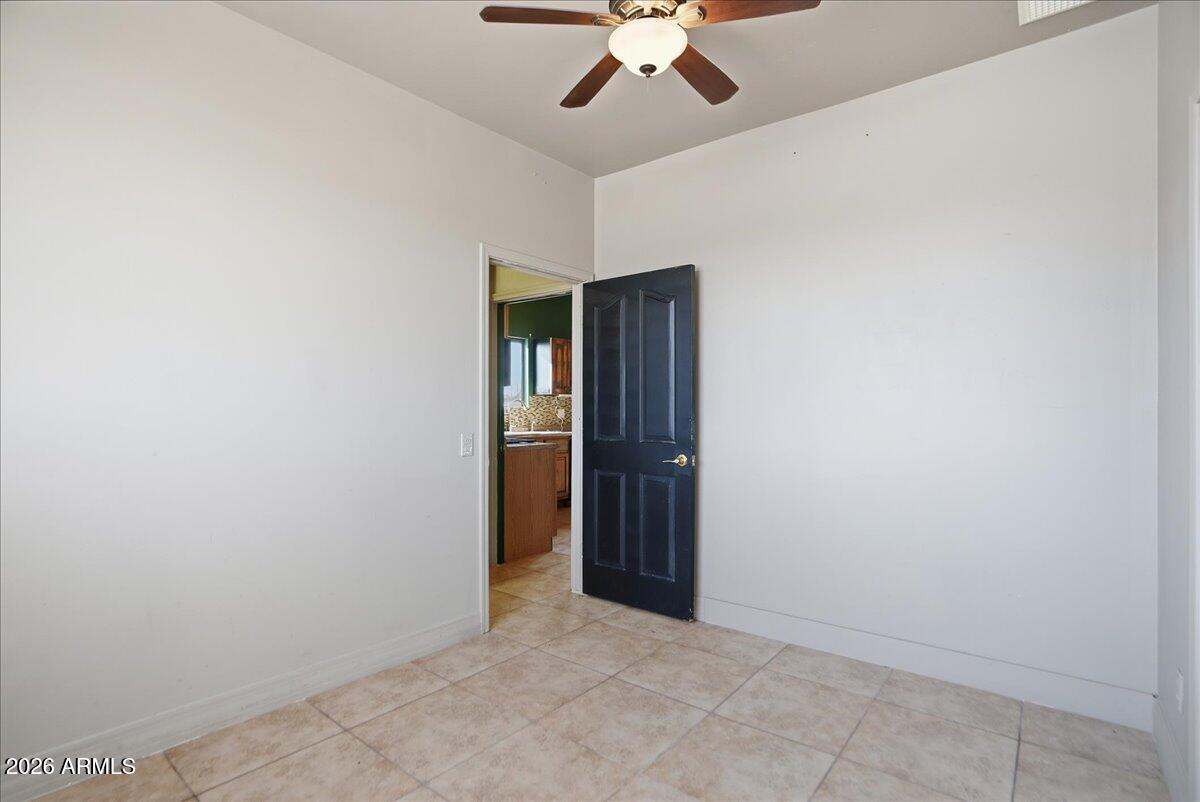 1414 West Ocotillo Road San Tan Valley, AZ 85140 - Photo 38 of 62 an empty room with closet and a chandelier fan