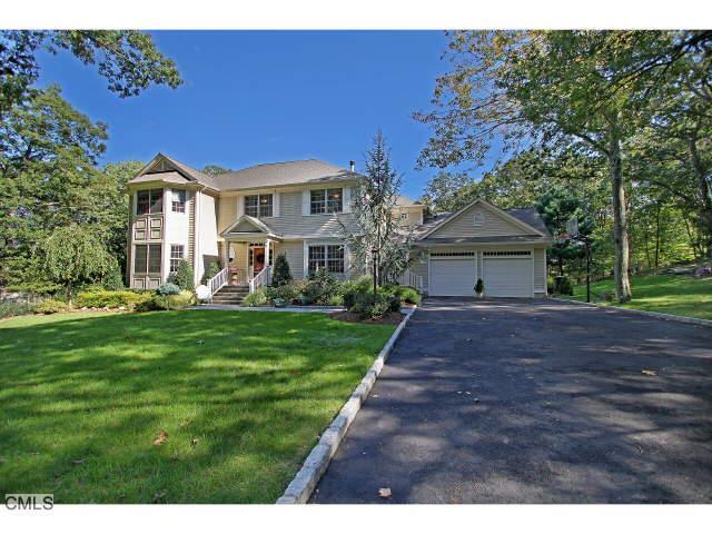 80 Rock Ridge Road Fairfield, CT 06824 - Photo 1 of 1 a front view of a house with a yard and garage