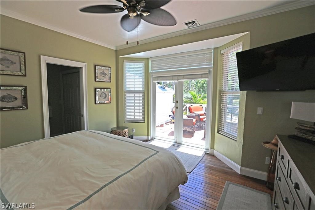 508 Useppa Island Bokeelia, FL 33922 - Photo 11 of 22 a bedroom with a bed and a flat tv screen on dresser