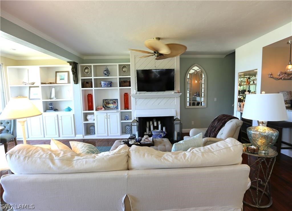 508 Useppa Island Bokeelia, FL 33922 - Photo 2 of 22 a living room with furniture a flat screen tv and a fireplace