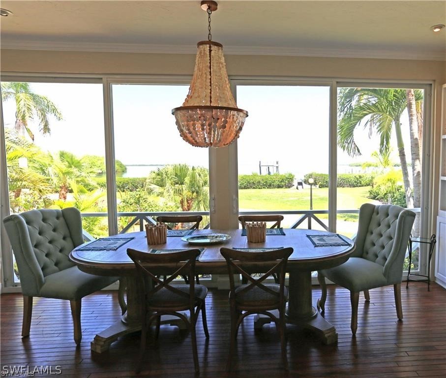 508 Useppa Island Bokeelia, FL 33922 - Photo 4 of 22 a view of a dining room with furniture window and wooden floor