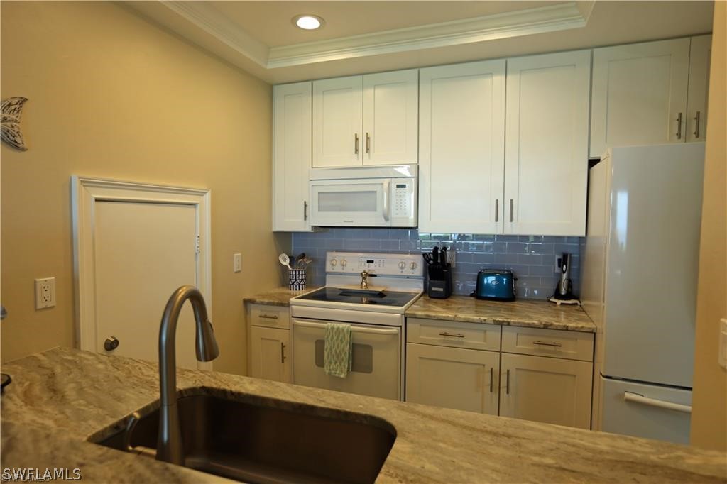 508 Useppa Island Bokeelia, FL 33922 - Photo 8 of 22 a kitchen with stainless steel appliances granite countertop a sink a stove and cabinets