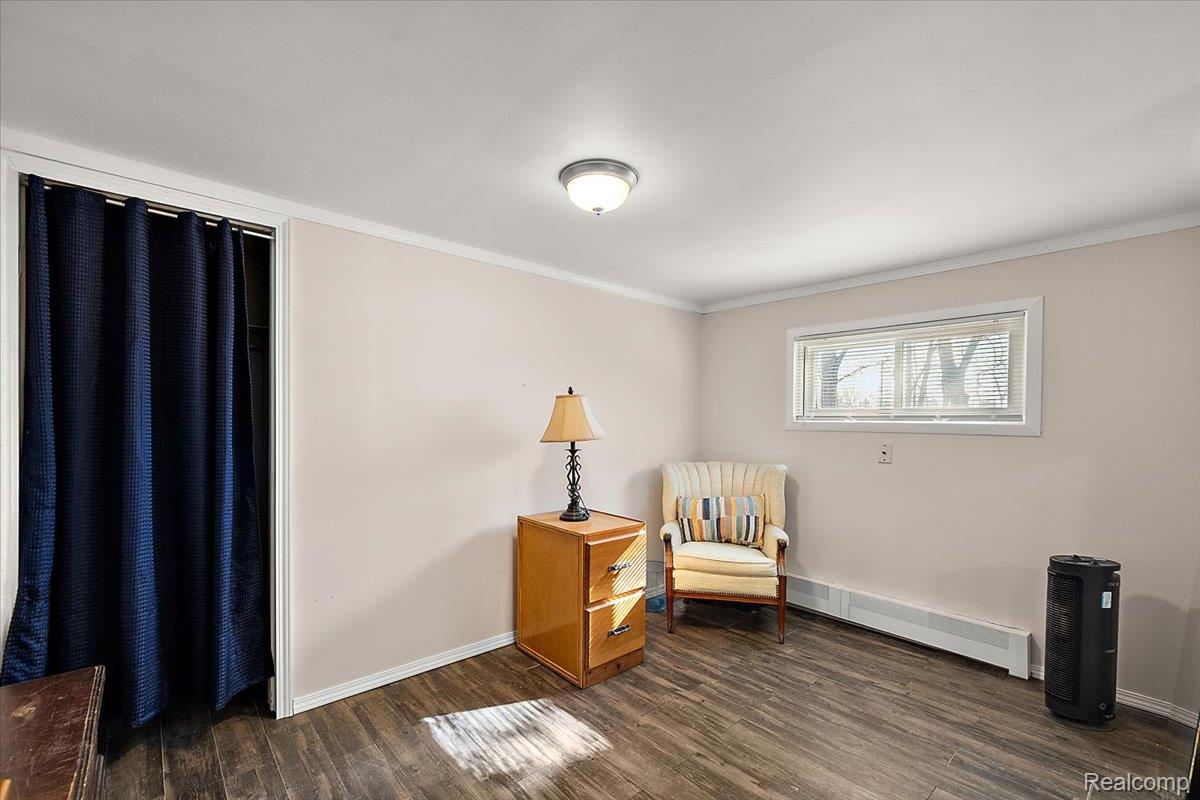 4705 Ketchum Road St. Clair, MI 48079 - Photo 35 of 58 Sitting room featuring crown molding, dark wood-type flooring, and a baseboard radiator