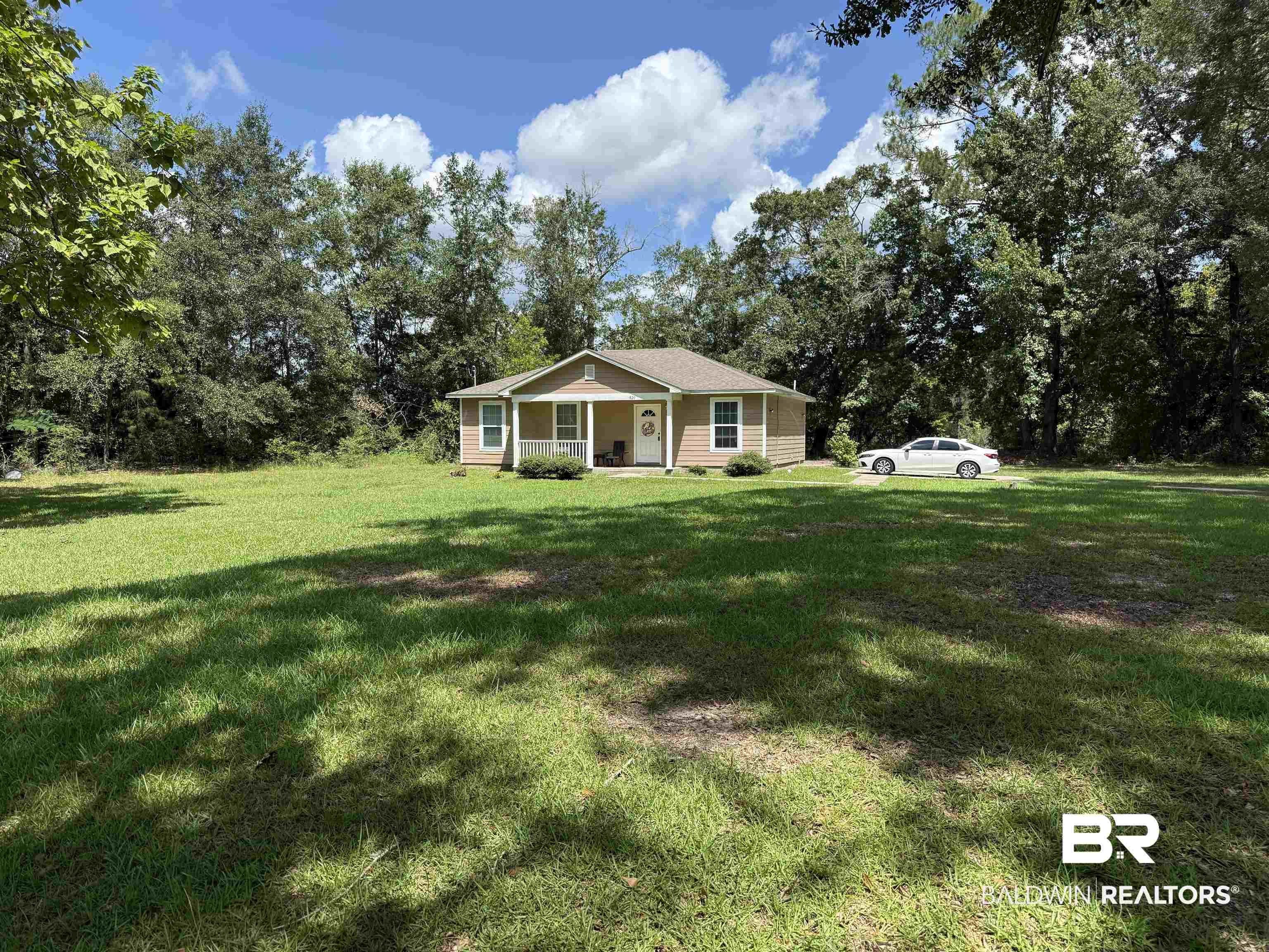 820 Fannie Road Century, FL 32535 - Photo 8 of 29 View of front facade featuring a front lawn and covered porch
