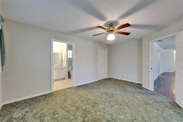 a white toilet sitting next to a window in a bathroom