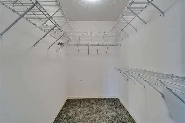 a view of a room with a ceiling fan and a chandelier fan
