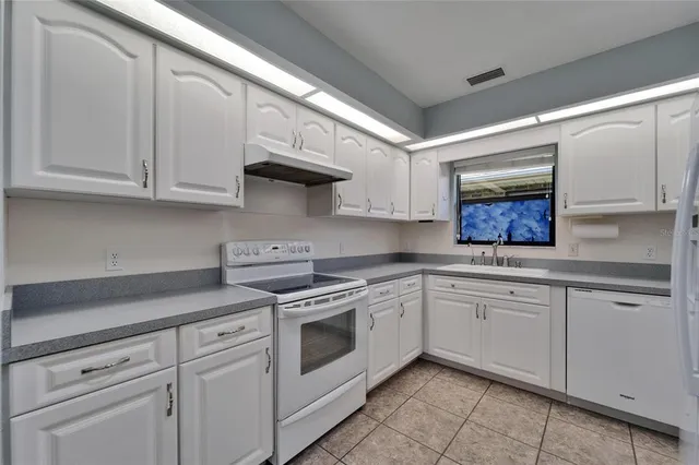 an aerial view of a house with outdoor space and lake view