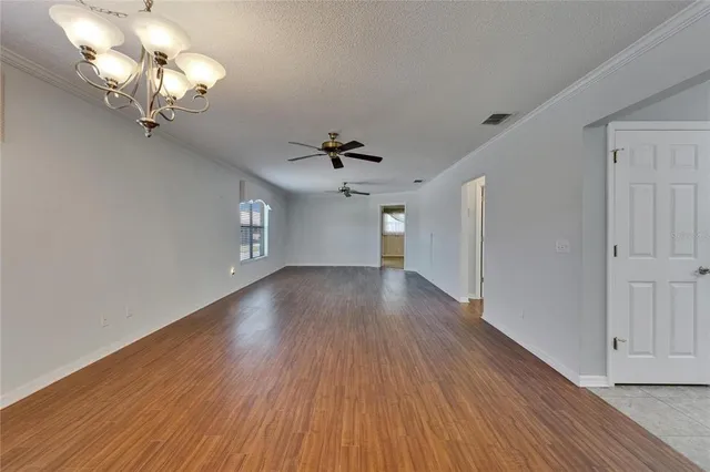 a kitchen with a sink a refrigerator and cabinets