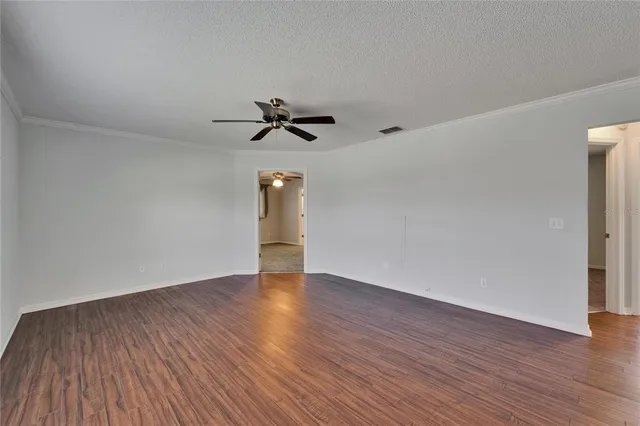 a view of a kitchen with cabinets and wooden floor