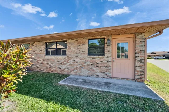 an aerial view of a house with garden space and street view