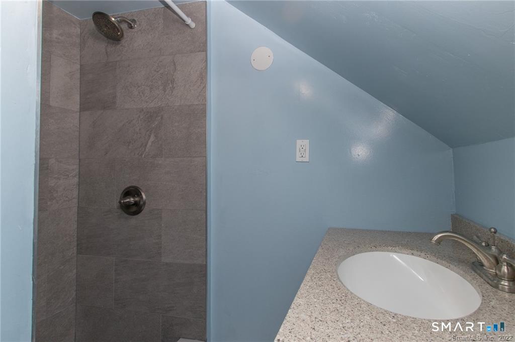18 Lawrence Street Norwalk, CT 06854 - Photo 27 of 31 a bathroom with a sink and toilet