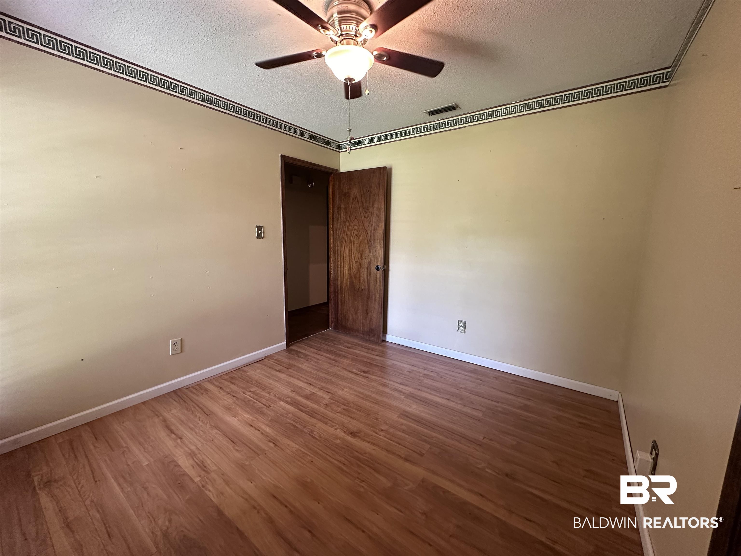 3613 Vista Ridge Drive Mobile, AL 36693 - Photo 8 of 9 Spare room with a textured ceiling, hardwood / wood-style floors, and ceiling fan