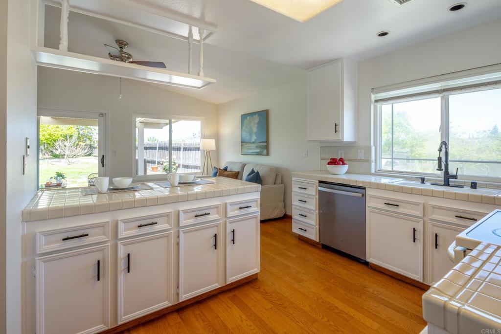 2236 Casa Cielo Spring Valley, CA 91977 - Photo 9 of 20 a kitchen with sink cabinets and window
