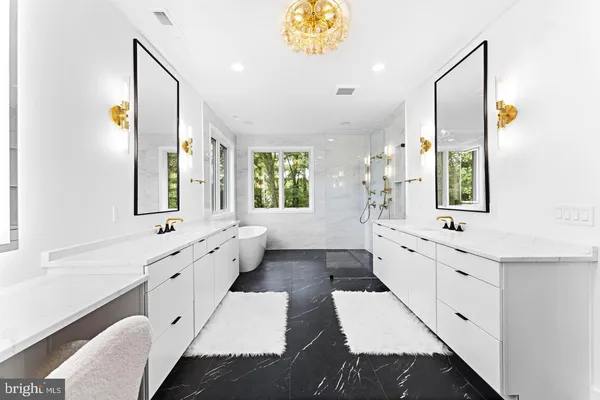 a large bathroom with a double vanity sink a mirror and a bathtub