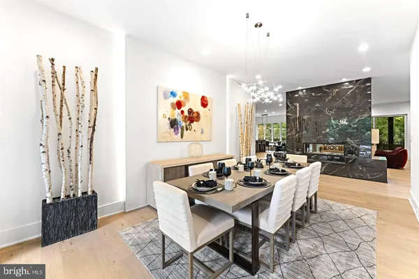 a dining room with furniture a rug and a chandelier